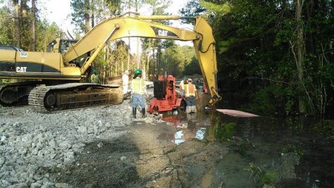 Workers dealing with water at the repair site in Brunswick County. Courtesy of the Cape Fear Public Utility Authority.