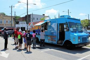 As people order and get their food, Evans goes around to each person, exchanging a word, shaking hands and giving hugs. If they need something, all they have to do is ask, and he said he'll do his best to be a friend for them. (Port City Daily photo / CORY MANNION)