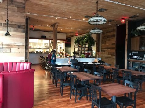 The interior has come a long way from the abandoned warehouse it once was. At the counter, Andrew Sutton and Ben Knight compare notes. (Port City Daily photo / BENJAMIN SCHACHTMAN)