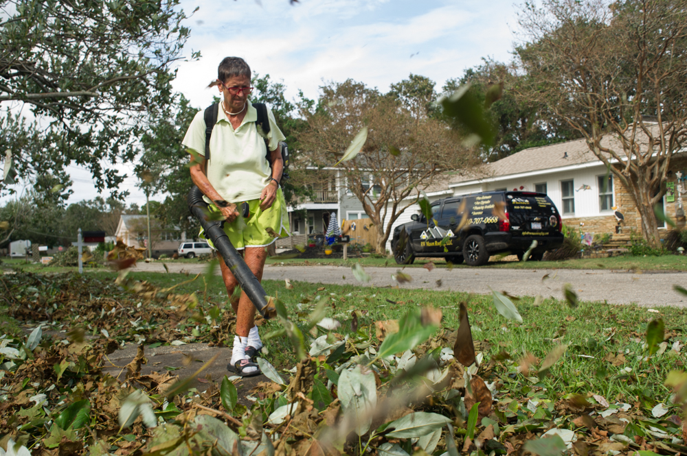 Betsy McQuillen blows leaves from her yard on the corner of 3rd and Lumberton in Carolina Beach Monday, September 17, 2018. "I've stayed at every storm we've ever had," McQuillen said. (Port City Daily photo | Mark Darrough)