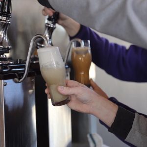 Two of Flying Machine's newest releases, the Tiki Treat Kölsch and a Blueberry Cobbler Bock. (Port City Daily photo/Courtesy Flying Machine Brewing Co.)