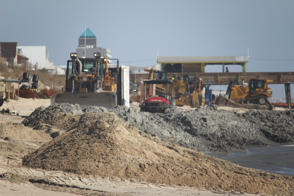 Heavy equipment can be seen on the beach moving tons of sand to help widen the shore (Port City Daily/Michael Praats)