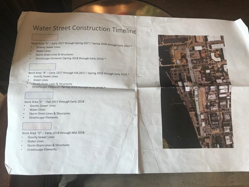 Chad Bean, a Water Street business owner, received this map and timeline of the CFPUA sewer project two years ago, but things haven't gone according to plan. (Port City Daily photo / Benjamin Schachtman)