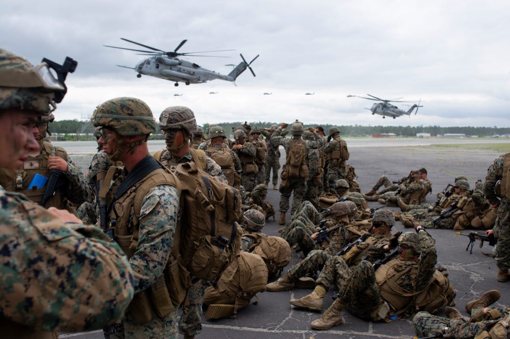 Ch-53 Stallions land at Bogue Airfield as infantry units from the 2nd Marine Division turn away from the dust and high winds. (Port City Daily photo/Mark Darrough)