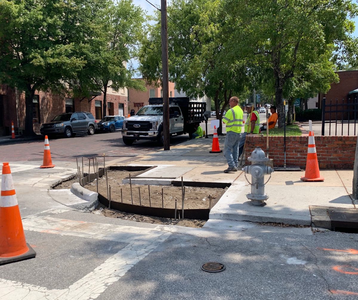 Construction crews tore out the curbs at Dock and Front streets in downtown Wilmington. It's not clear from whom they were working. (Port City Daily photo / Benjamin Schachtman)