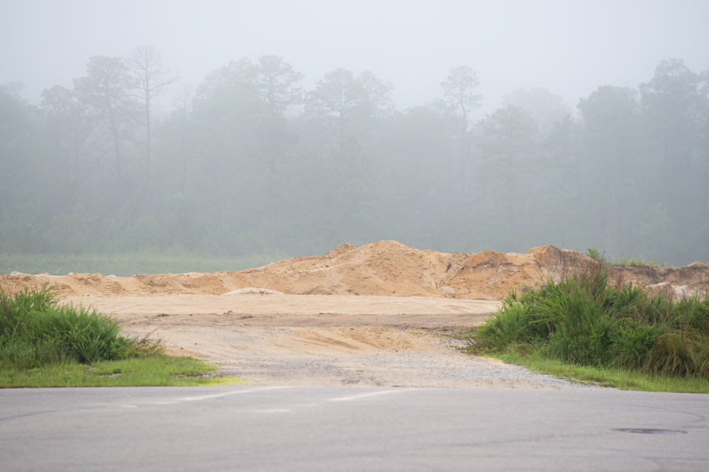 An open lot at Pender Commerce Park adjacent to the Acme Smoked Fish building. (Port City Daily photo/Mark Darrough)