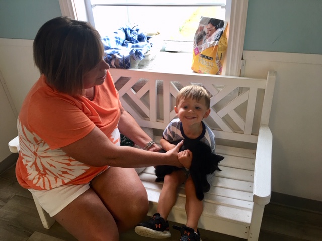 Reid Arthur, age three, practices holding Batts with his grandmother, Kim Wiles. (Port City Daily photo / Samira Davis)