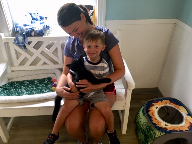 Reid Arthur, age three, sits on his mother Sarah Arthur’s lap, while holding his favorite shelter kitten Batts. (Port City Daily photo / Samira Davis)