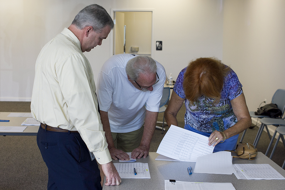 David Hollis (left) speaks with Brunswick Forest property owners at a town-organized petition signing session Friday. (Port City Daily photo/Johanna Ferebee)