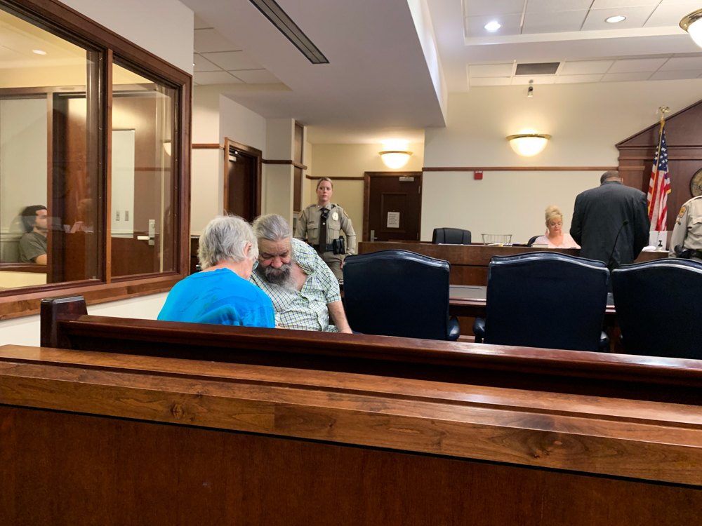 Robert Woody, Jr. and his wife, Judy Woody, consult over paperwork to delay their court hearing to March 12. (Port City Daily photo/Mark Darrough)