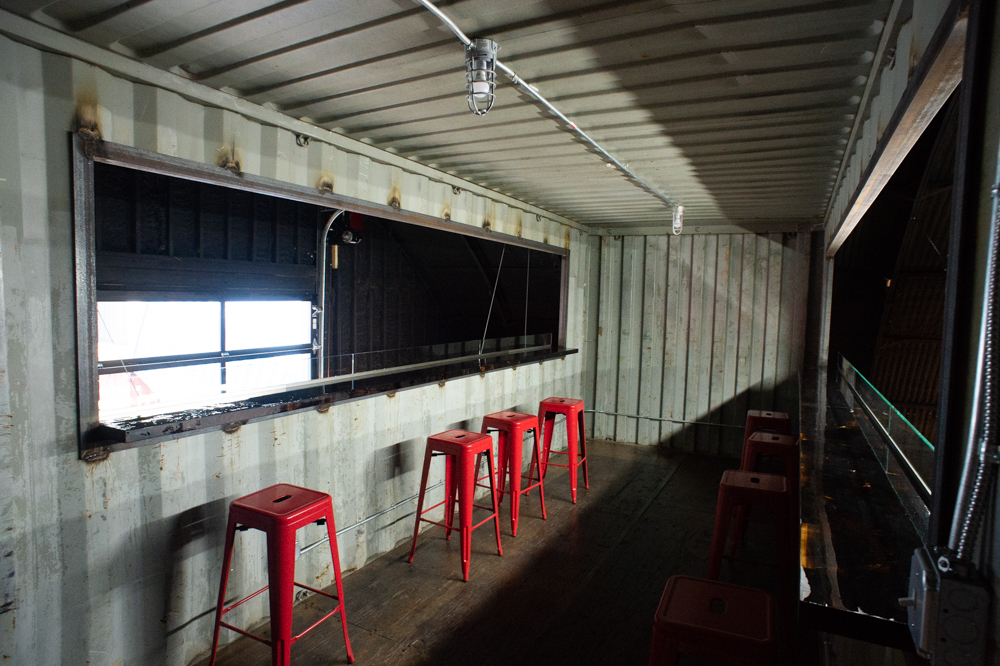 A shipping container for upstairs seating has been installed above the bar. (Port City Daily photo/Mark Darrough)