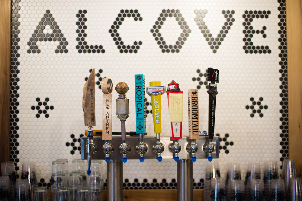 The current tap lineup includes (from left to right) local beers from Wrightsville Beach Brewery, New Anthem, Flying Machine, Wilmington Brewing Co., Waterline, Hi-Wire (Asheville), Broomtail, and Edward Teach. (Port City Daily photo/Mark Darrough)