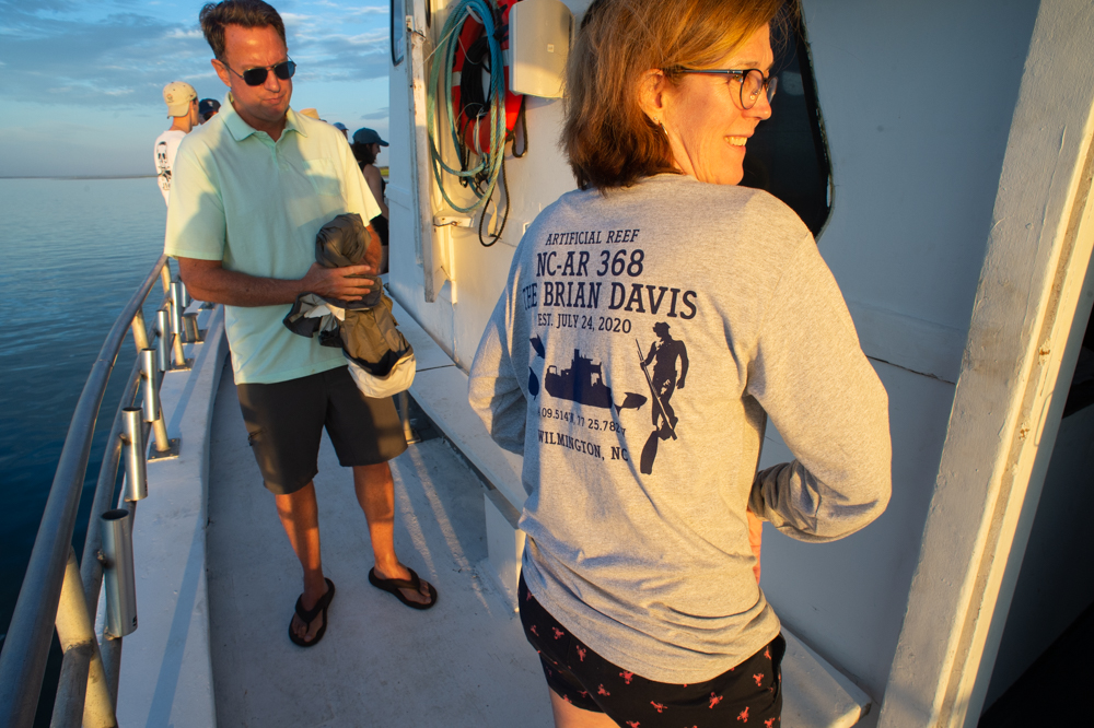 Kathy Davis shows off t-shirts she had made for the day while her brother, Mark Darwin, looks on. (Port City Daily photo/Mark Darrough)