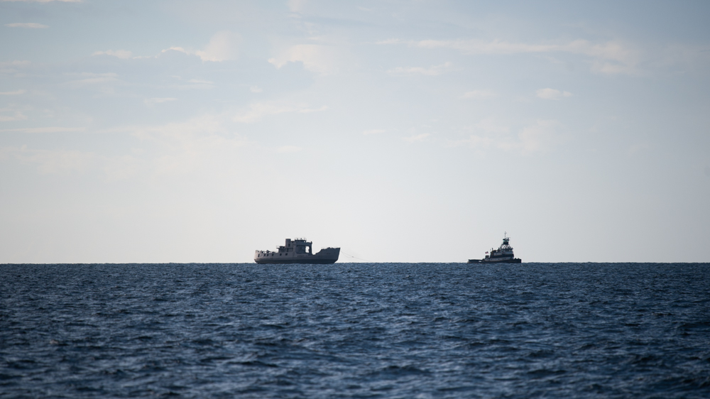 The Coast Guard cutter, rechristened The Brian Davis, is seen in the distance. "The boat looks so much bigger in person -- when you see a beautiful silhouette against the sky, it’s really incredible," Kathy Davis said. (Port City Daily photo/Mark Darrough)