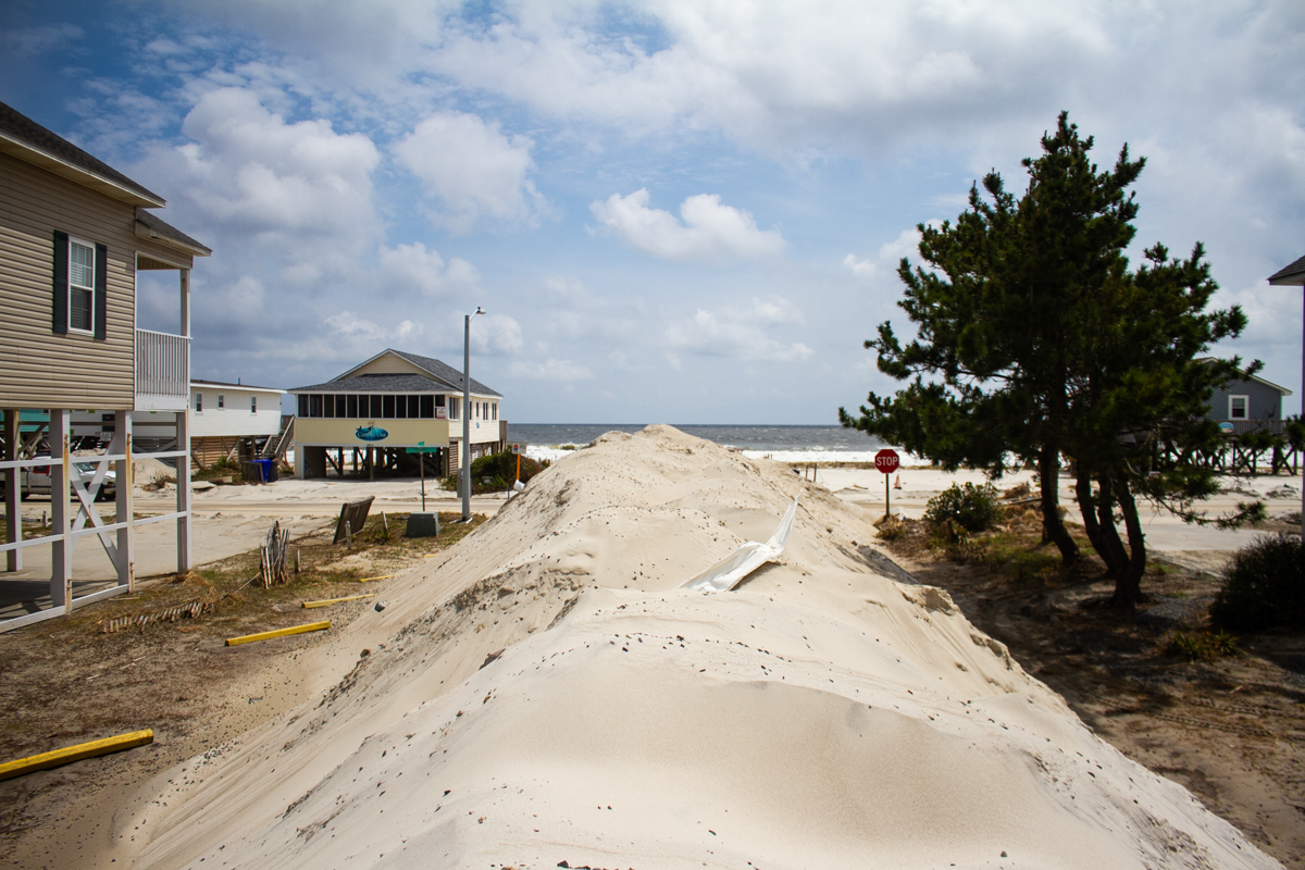 Piles of sand, many littered with debris, have accumulated across Oak Island after Hurricane Isaias. (Port City Daily photo/Johanna F. Still)
