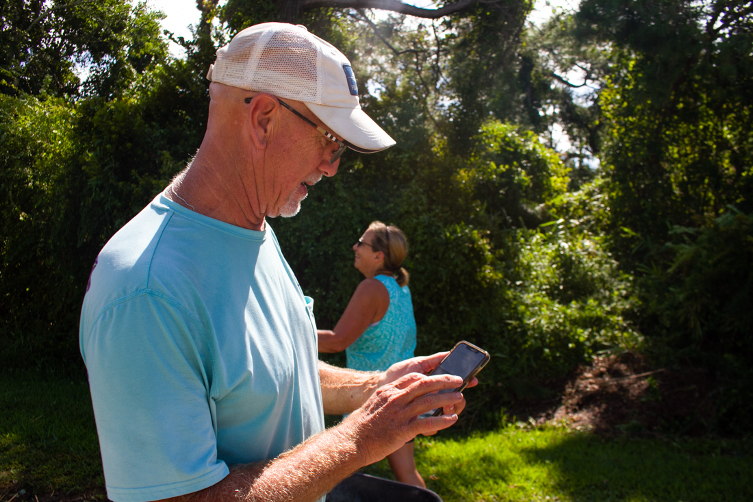 Kevin Kirby pulls up pictures of the house fire he witnessed early Tuesday morning from his home, located about two blocks inland. (Port City Daily photo/Johanna F. Still)